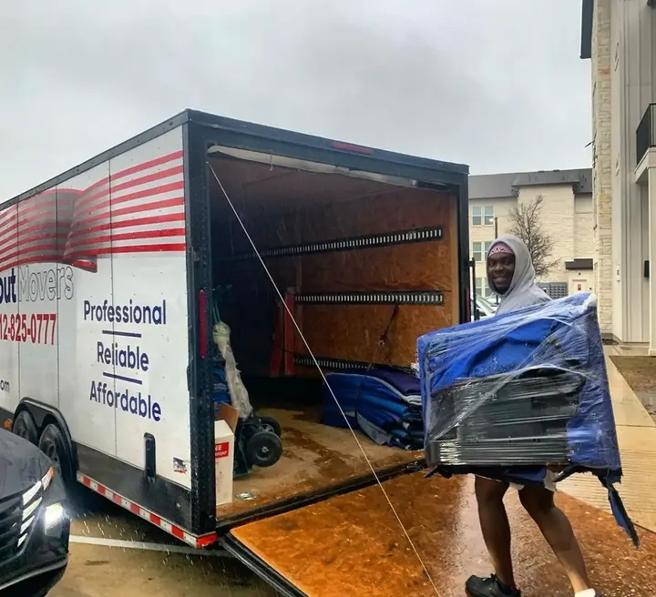inNout Movers team member loading wrapped furniture onto a ramp