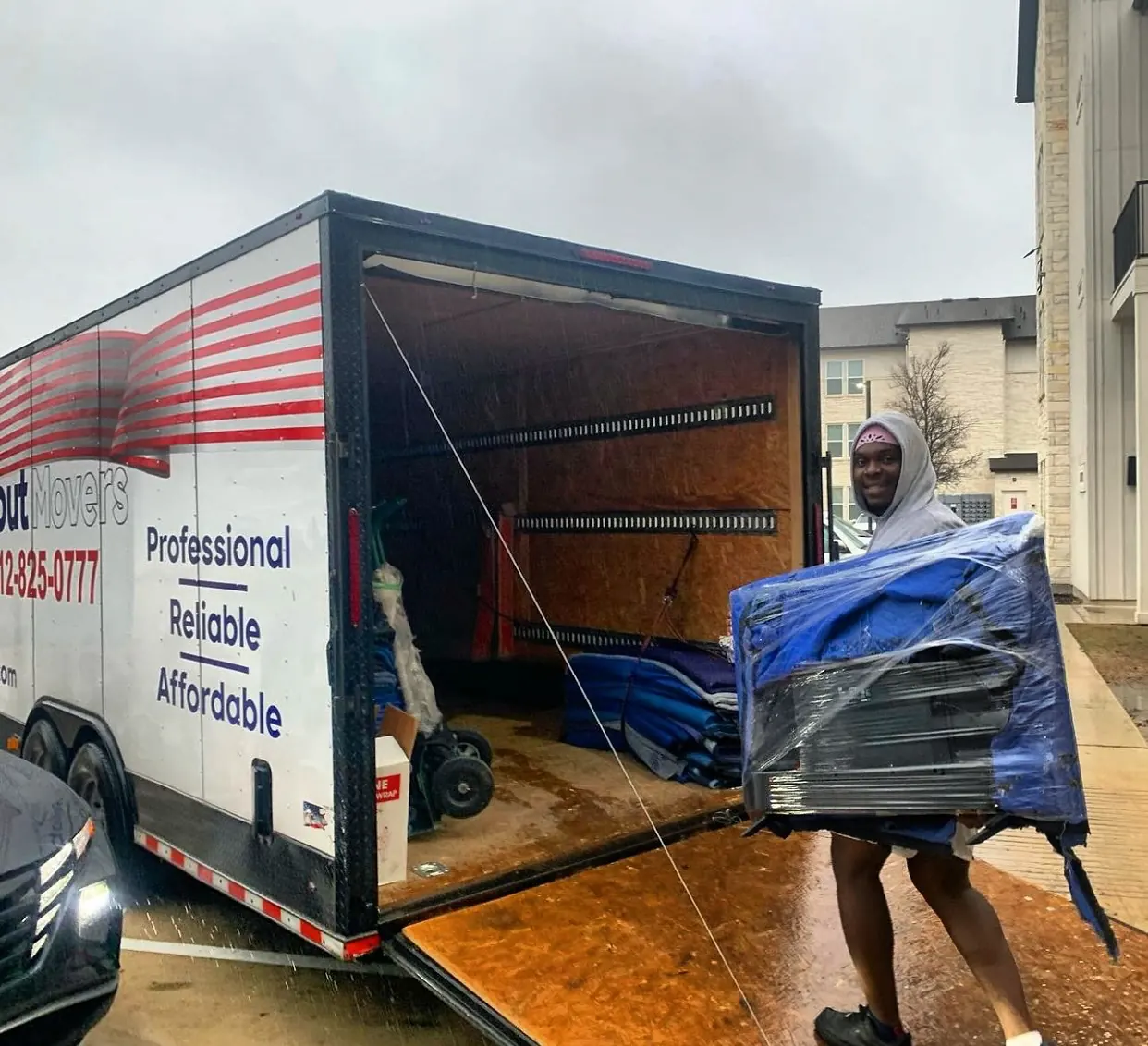 inNout Movers team member loading wrapped furniture onto a ramp