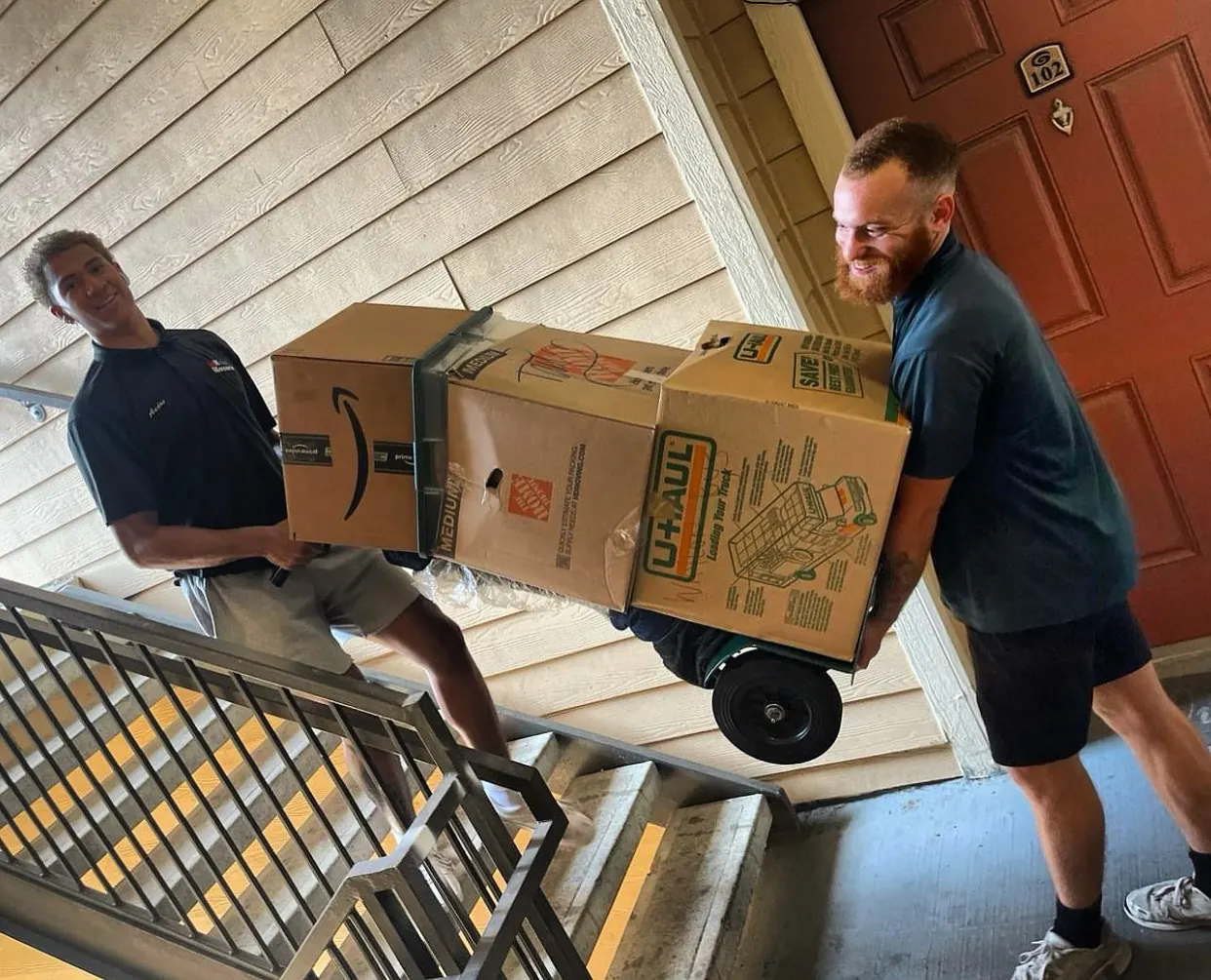 inNout Movers team member moving boxes on apartment stairs